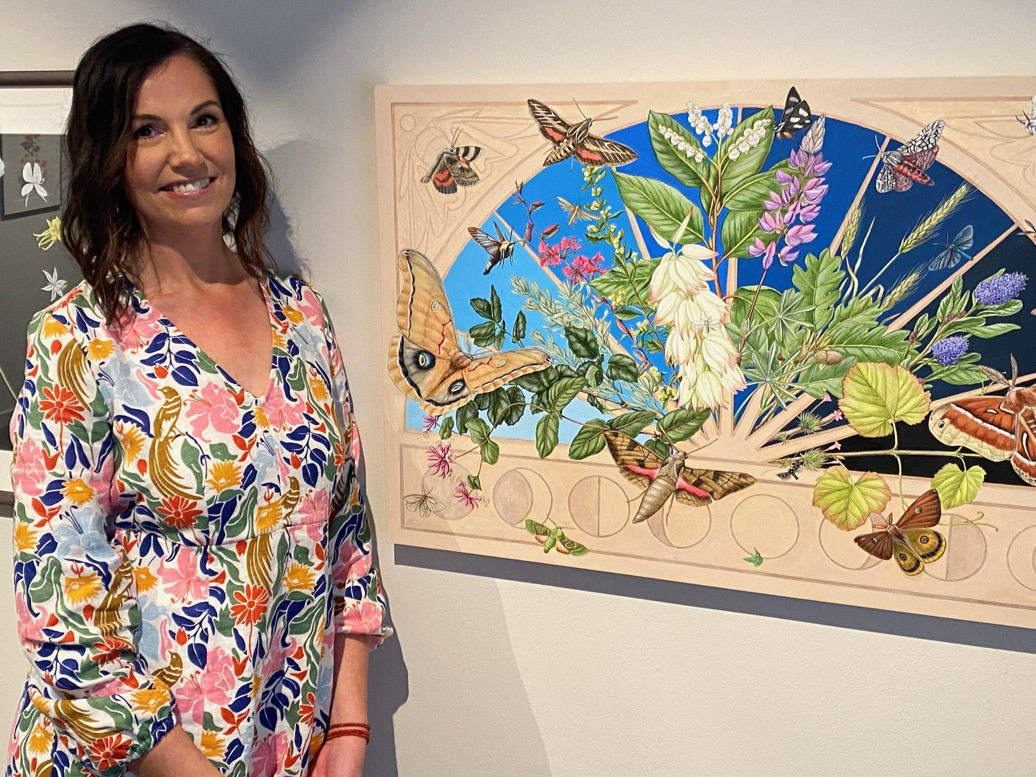 Erin Hunter stands next to her painting Emergence at the Monterey Museum of Art
