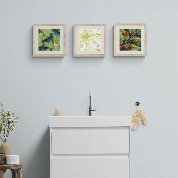 3 insect paintings shown in a bathroom